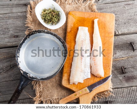 raw fish fillets for frying on pan. kitchen composition.