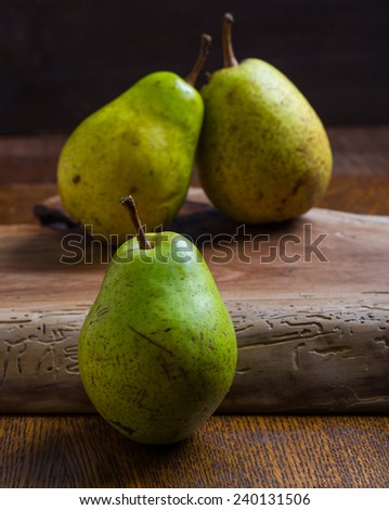 green pears on wooden table