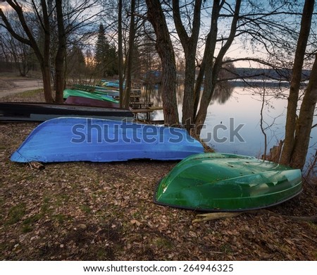 Beautiful lake landscape with boats on shore. Polish lake in Mazury lake district.