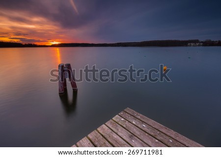 Beautiful long exposure landscape of lake in Mazury lake district (Krzywe lake near Olsztyn).