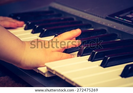 Close up of Keyboard of synthetizer. Music abstract background with hands of children playing on keyboard.