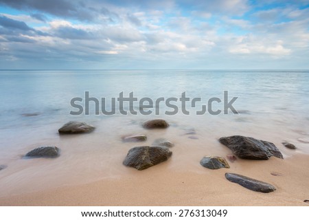 Beautiful long exposure landscape of rocky sea shore. Tranquil scene of Baltic sea near Gdynia in Poland.
