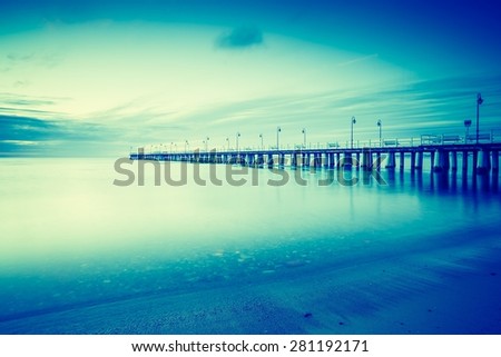 Vintage photo of beautiful long exposure seascape with wooden pier. Pier in Orlowo, Gdynia in Poland.