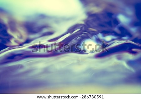 Abstract background of moving water surface in big close up. Photo with vintage colors.