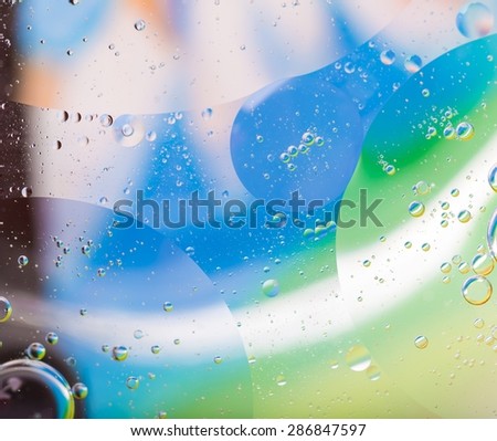 Abstract background of oil droplets on water surface. Beautiful and colorful macro abstraction