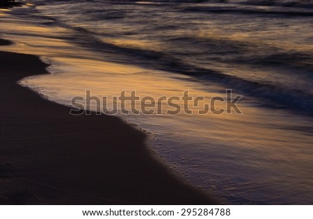 Beautiful Baltic sea beach at sunset. Beautiful seascape with sky reflected in water.