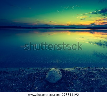 Vintage photo of beautiful lake sunset. Polish lake in Mazury lake district. Polish lake landscape
