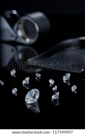 diamond on a black background with other diamonds, and  stone shovel, diamond cut loupe