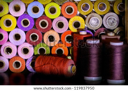 many colorful spools of thread for sewing, colorful background