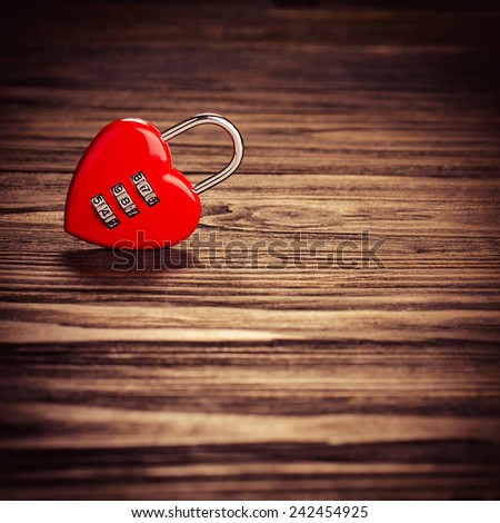 Heart lock on old wood background, with vintage filter.Valentines Day background.