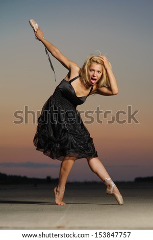 Professional gymnast woman dancer posing on concrete road