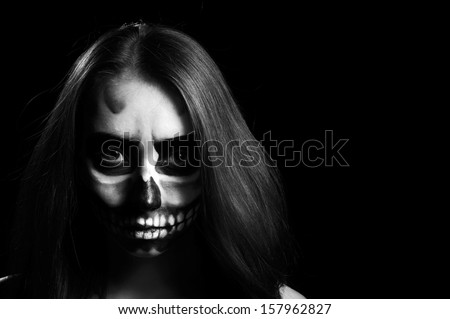 Young woman in day of the dead mask skull face art. Halloween