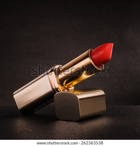 red lipstick on a black textured background