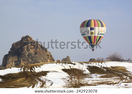 Goreme,Cappadocia Turkey - February 25, 2012: Hot air balloon just about to land to the ground after finishing of its flying over Cappadocia area in the early morning.