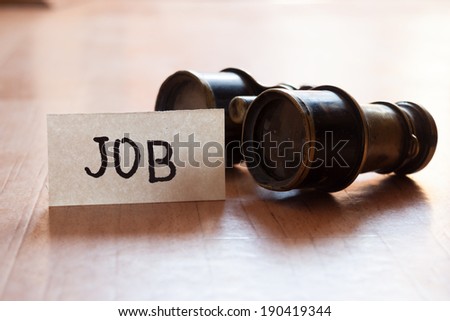 Looking for a job concept, sign job and vintage binoculars.
