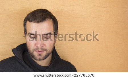 Closeup of handsome man with eyes closed against yellow background
