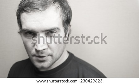 Black and white portrait of young good looking man, blurred. Photo for background.