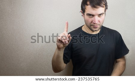 young and handsome man pointing up with his finger