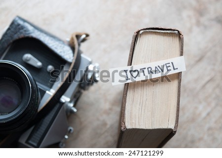text I Love Travel, book and old camera