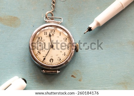 Retro background, old watches and pen on a blue background, vintage school.