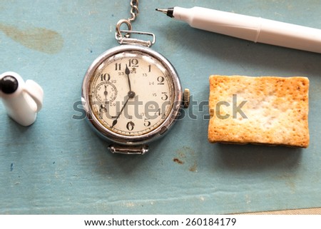 Retro background, old watches and pen on a blue background, vintage school.