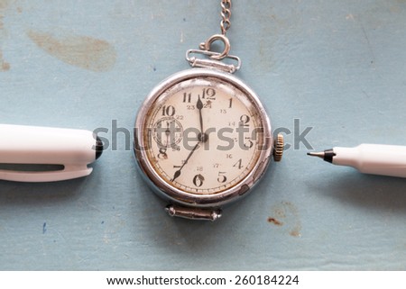 Retro background, old watches and pen on a blue background, vintage.