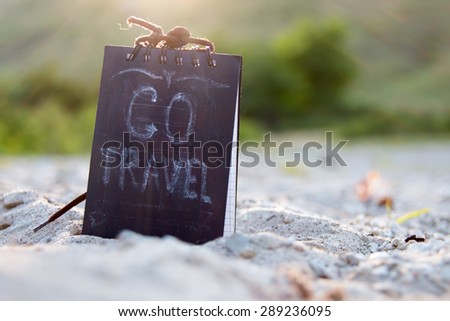 Go Travel - chalk lettering, sign on the beach.