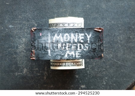 Money needs me concept. The inscription in chalk and dollars.