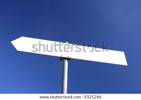 blank white direction board with blue sky in the background