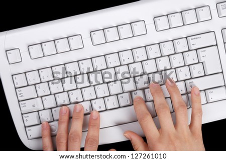 White keyboard is on black background.