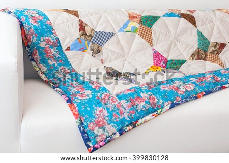 Patchwork quilt. Part of patchwork quilt as background. Flower print. Color blanket in style patchwork. Color blanket.  Handmade.