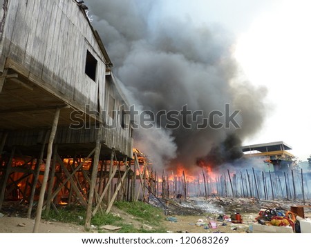 MANAUS, BRAZIL - NOV 27:  Large fire destroys countless stilt houses in the district of Sao Jorge in Manaus Amazonia. About 50 homes were destroyed by fire. Brazil, Nov 27, 2012