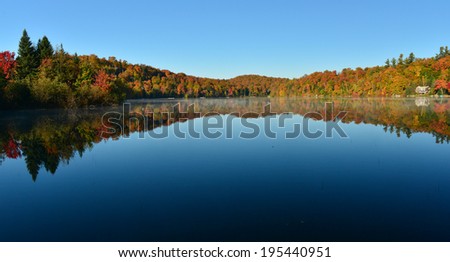 The Laurentian forest in the fall with reflections in a lake, Quebec, Canada