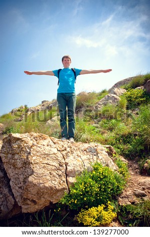 healthy young man on a hill in the mountains