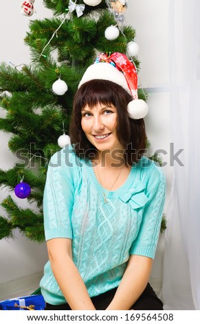 Young girl with gifts under the Christmas tree