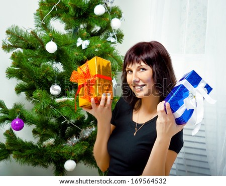 Young girl with gifts under the Christmas tree
