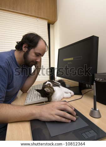 Man waiting for loading a pc application, with his cat