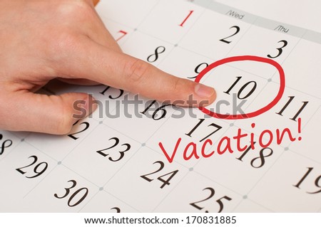 The word vacation is written and circled on a white calendar page