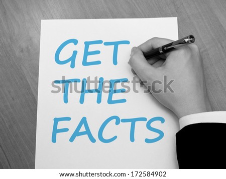 Businessman writing on a sheet of paper Get the facts