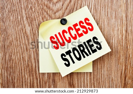 Success Stories Concept written on the paper on a wood background