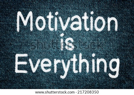 Motivation is Everything. Business message text written on a stylish grunge jeans background