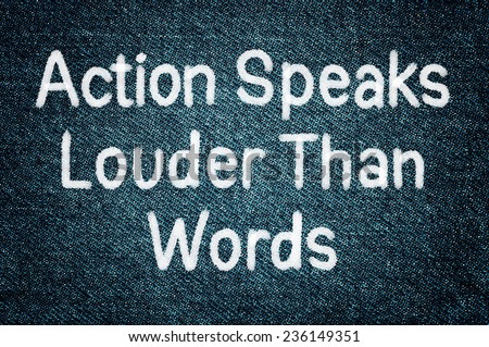 Action Speaks Louder Than Words Concept written on grunge jeans background