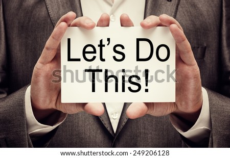Let\'s Do This! Motivational slogan in businessman\'s hands