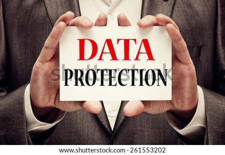 Data Protection. Businessman with a card in his hands showing Data Protection text