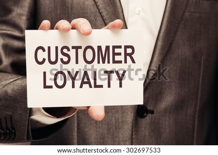 Customer loyalty card in businessman hand