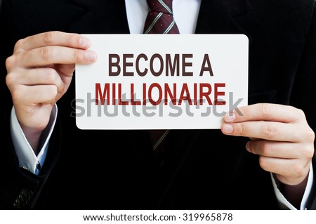 Become a Millionaire. Man holding a card with a message text written on it