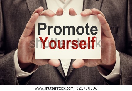 Businessman holding Promote yourself card