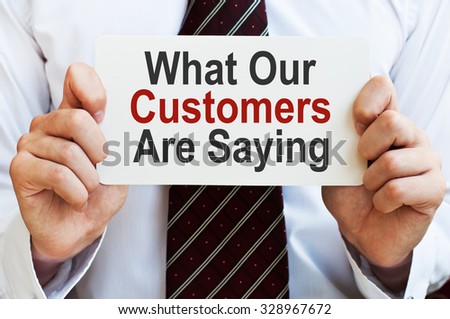 What Our Customers are Saying. Businessman holding a card with a message text written on it