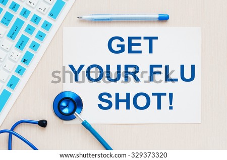 Get Your Flu Shot ! written on a paper on table, top view