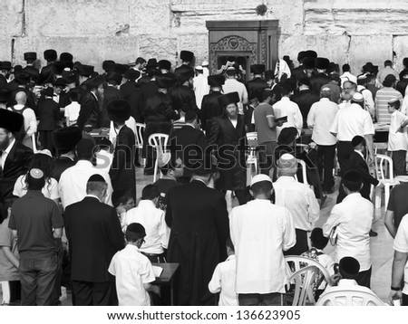 JERUSALEM - MARCH 31: Jewish Religious men praying in front of the Western Wall at their most important holiday, which is Passover. March 31, 2013 in Jerusalem, Israel.